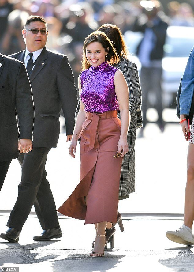 Touch of bling: The stunner sported diamond encrusted hoop earring and a pair of gold-rimmed sunglasses