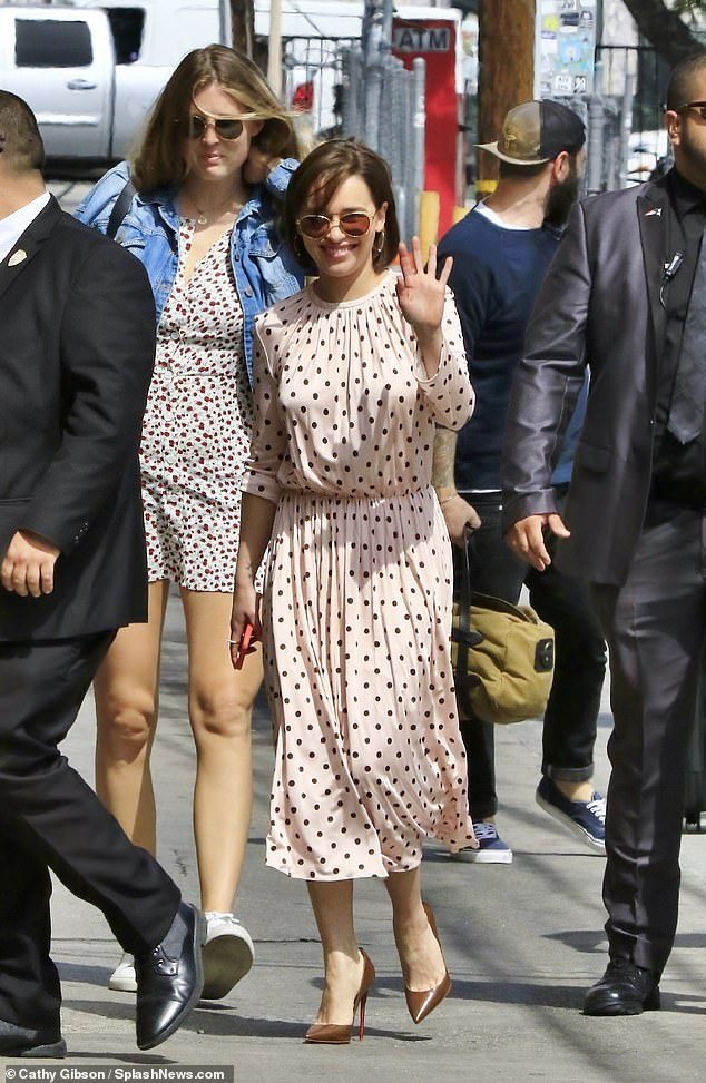 Out and about: She sported a pale pink pleated dress, cinched in at the waist and paired with bronze hued stilettos