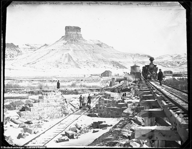 The Transcontinental Railroad's role in the expansion into the Wild West during the 1800s is highlighted in a fascinating new exhibition at the Oakland Museum of California. The Pacific Railroad, known later as the Overland Route, was built between 1863 and 1869. It connected trains in Omaha, Nebraska, in the east to San Francisco Bay in the west. Pictured: a temporary and permanent bridge built over the Green River with Citadel rock in the distance