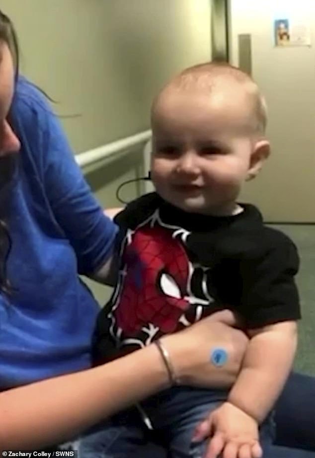 Everett beams and leans in towards his mother for comfort as he hears his parents for the first time