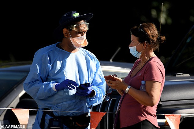 The PM urged anyone experiencing Covid-like symptoms like a runny nose, sore throat, cough or fever to seek a PCR test (pictured, people queue for a test in Sydney)