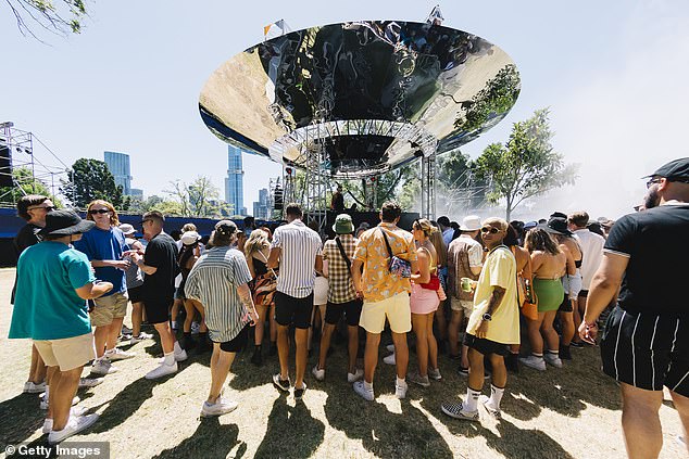 NSW, Victoria, Queensland, South Australia and the ACT will adopt the new definition of a close contact on Friday morning at midnight (pictured, revellers at a Melbourne concert on Thursday)