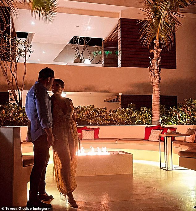 Kisses at night: Here they were leaning on each other as a fire pit roared in the background