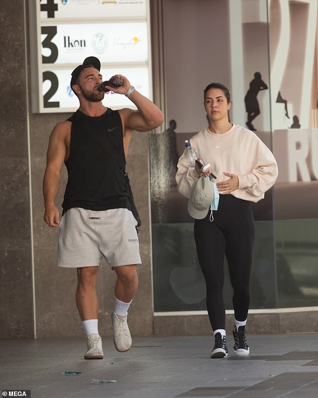 Thirsty work: Tobi sipped from a sports drink as they made their way outside