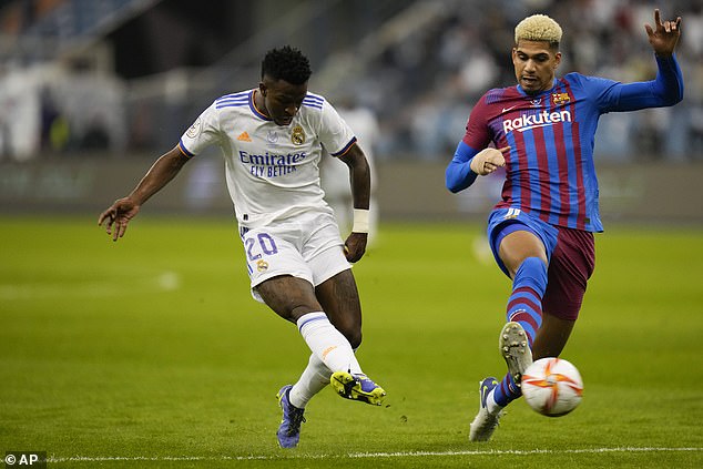 Araujo, here taking on Real's Vinicius Jr, is reportedly stalling on contract talks with Barcelona