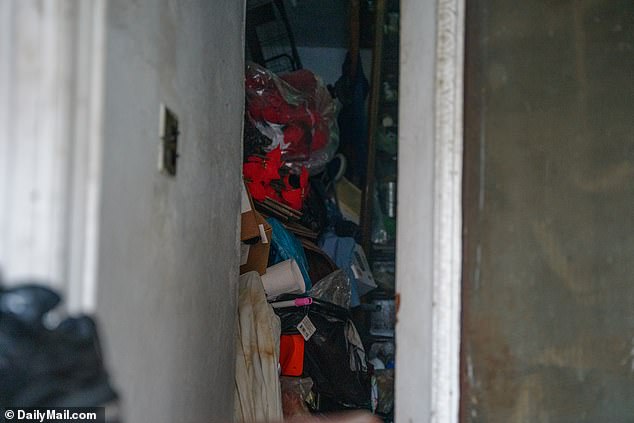 On Monday, the entry to the apartment building in Midwood was still filled with trash from floor to ceiling (pictured) and the area reeked of a foul stench