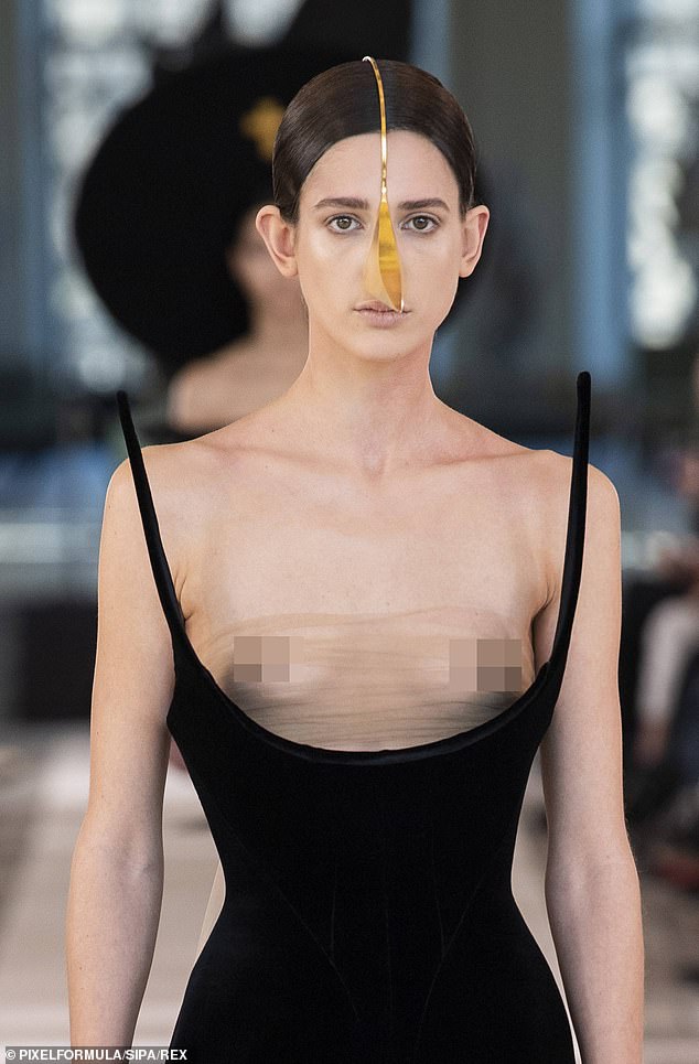 Forgotten something? One daring look featured a plunging black dress with a sheer mesh overlay on the bust that left nothing to the imagination