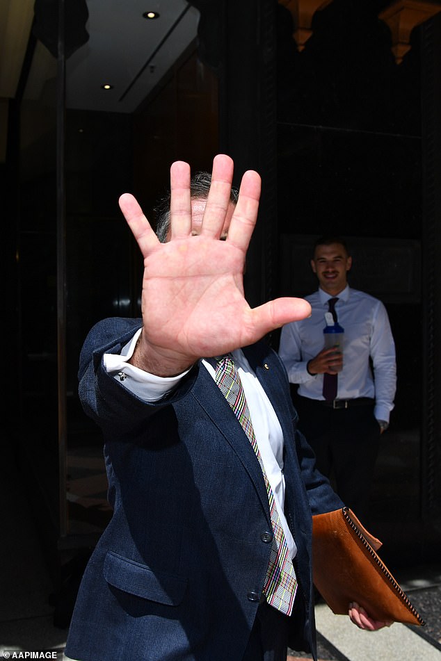 The 50-year-old is a former intellectual property lawyer. He appeared to swat a photographer with a folder shortly after this picture was taken in March 2019