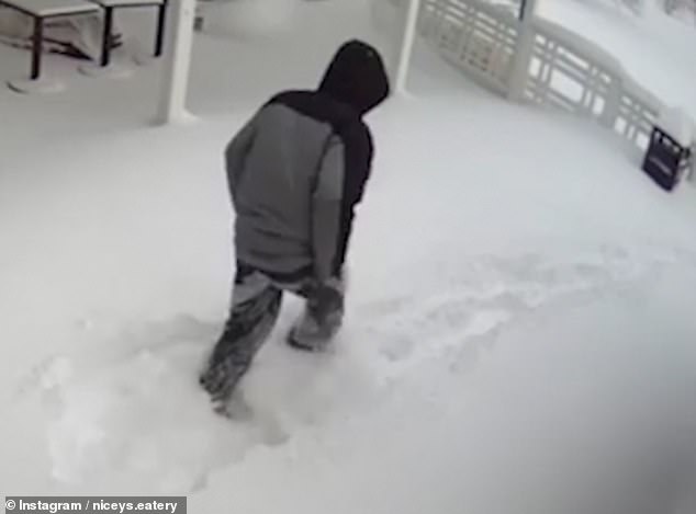 Disappointed, the mystery man gets himself out of the snow and turns to walk away from the restaurant