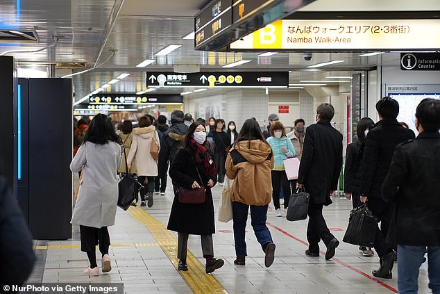 People wearing face masks inside Namba station in Osaka, Japan on January 27. State of Emergency measures are in place in the majority of Japan's prefectures