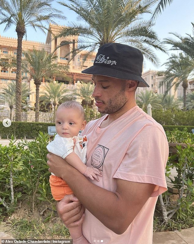 Doting dad: Alex could be seen holding baby Axel in his arms in his holiday pictures