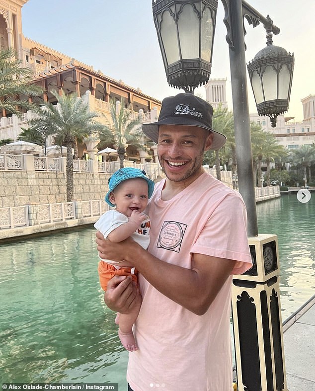 Happy family: Her post came shortly after her footballer partner Alex posted pictures of himself posing with five-month-old Axel while out in the sunshine at their hotel