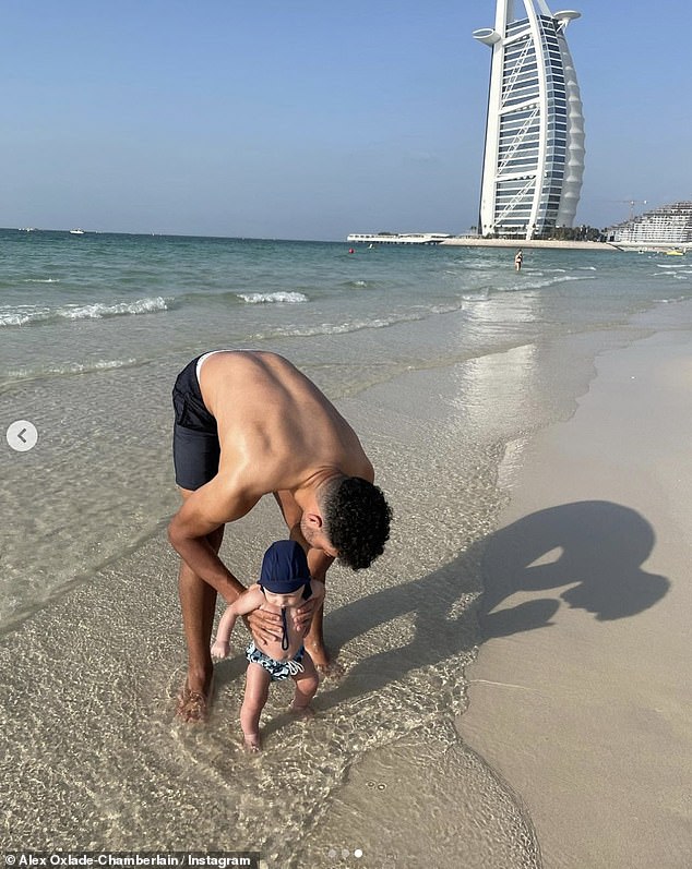 Keeping cool: Alex wore a pair of navy blue swimming shops and was shirtless, showing off his toned torso