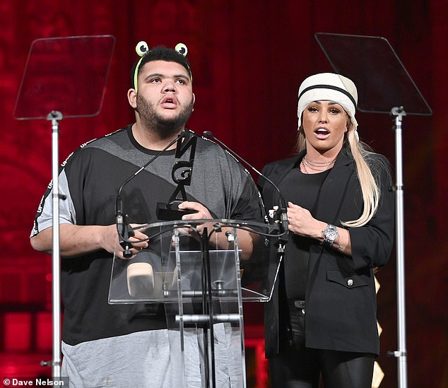 Winner: Harvey's famous mother, 43, proudly stood alongside him on stage behind the lectern after he picked up his award