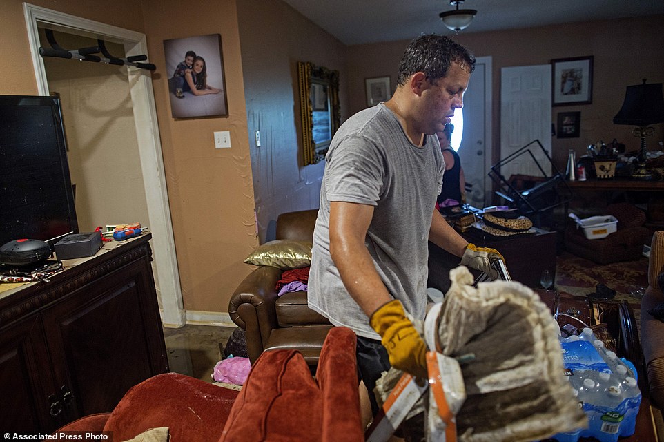 Raymond Lieteau cleans his Baton Rouge home damaged in the floods. Lieteau had more than five feet of water in his home