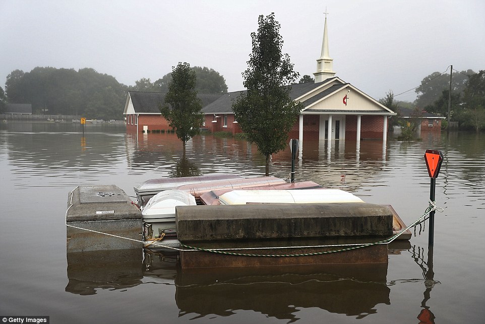 Caskets floatin flood waters near a cemetery on Wednesday in Gonzales, Louisiana.