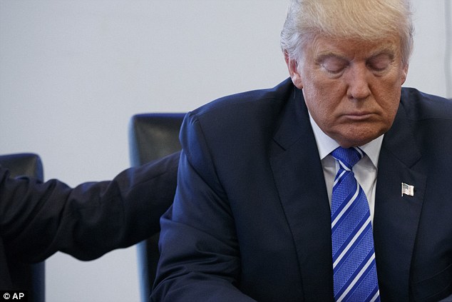 Republican presidential candidate Donald Trump pauses during a meeting with members of the National Border Patrol Council at Trump Tower, Friday, Oct. 7