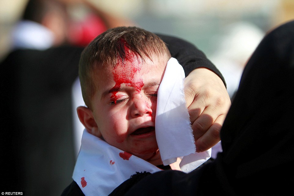 A Shi'ite Muslim child cries as he bleeds after being cut on the forehead with a razor during the religious procession in Nabatiyeh town, in southern Lebanon 