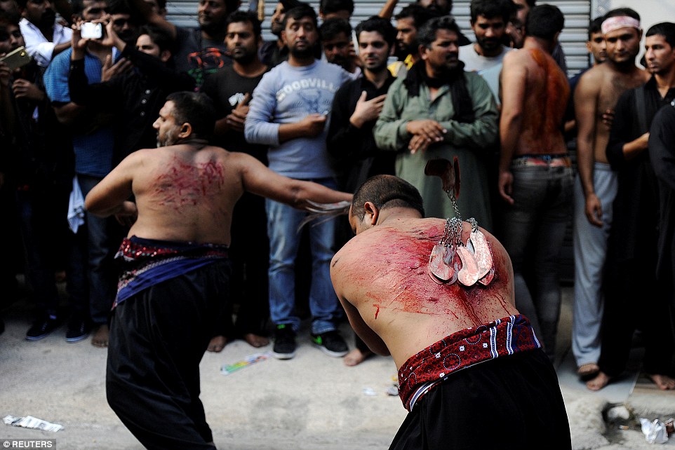 Men whip their own backs with blades attached to metal chains in Greece on October 12 